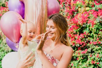 Happy adorable baby girl celebrates 1 year birthday