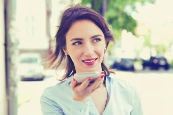 Woman using Siri function on iPhone