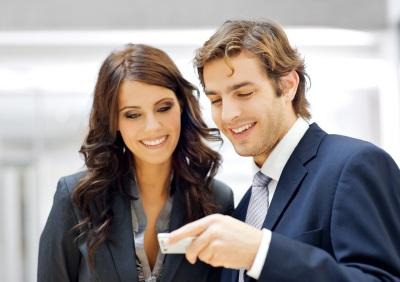 Business associates sharing information on phone