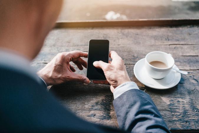 Man in cafe using cell phone