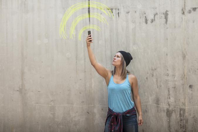 Woman looking for better phone signal