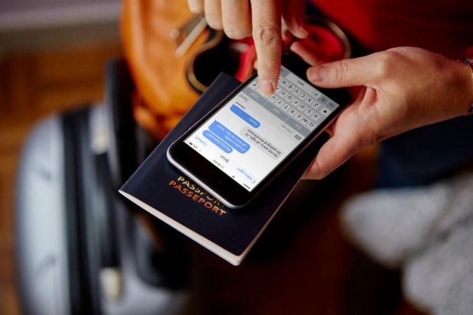 Woman holding passport and smartphone