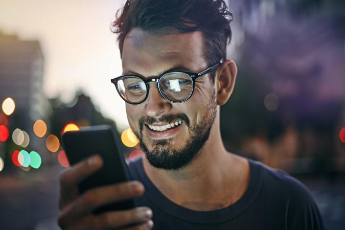 man reading text message