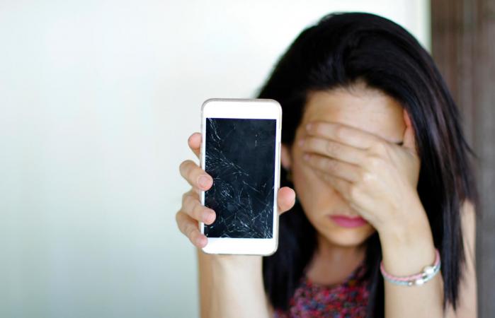 Woman Holding Broken Smart Phone