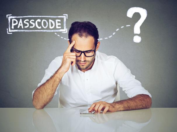 Man thinking about cell phone passcode