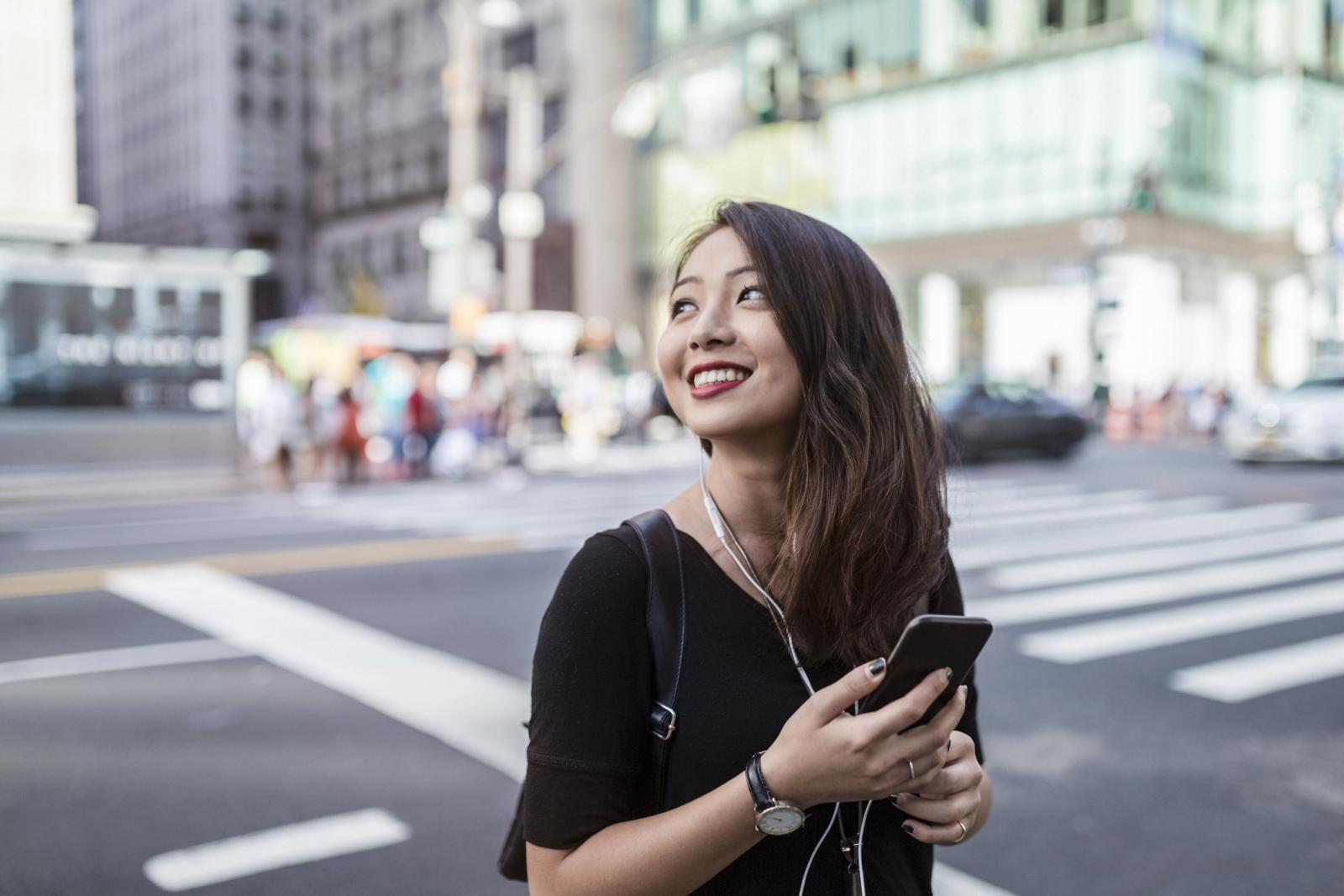 Young woman with cellphone on the street