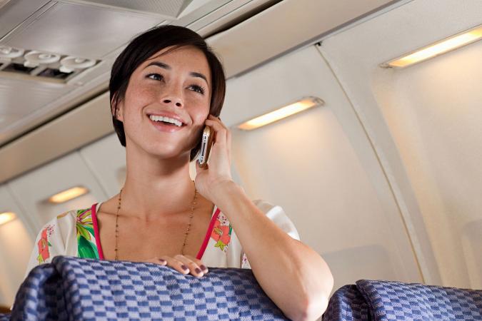 Woman on cellphone on airplane
