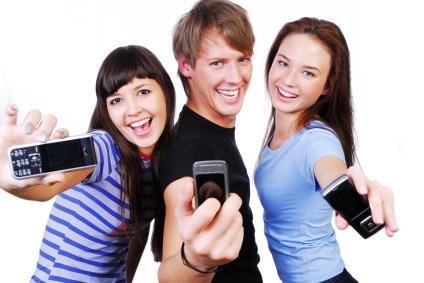 Three young people with cell phones