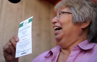 excited woman with an event ticket