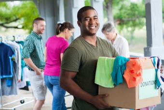 Man holding box of clothes donations