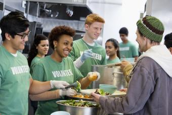 Volunteers working in a kitchen serving out food