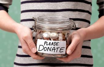 Child holding a charity donation jar 