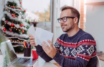 Man opening Christmas letter