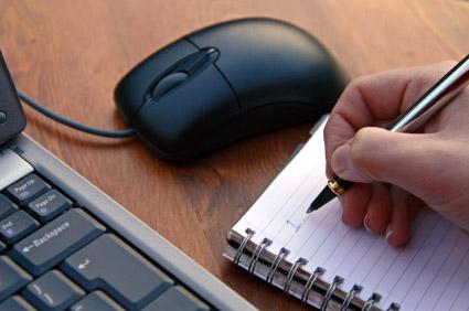 Taking notes next to computer