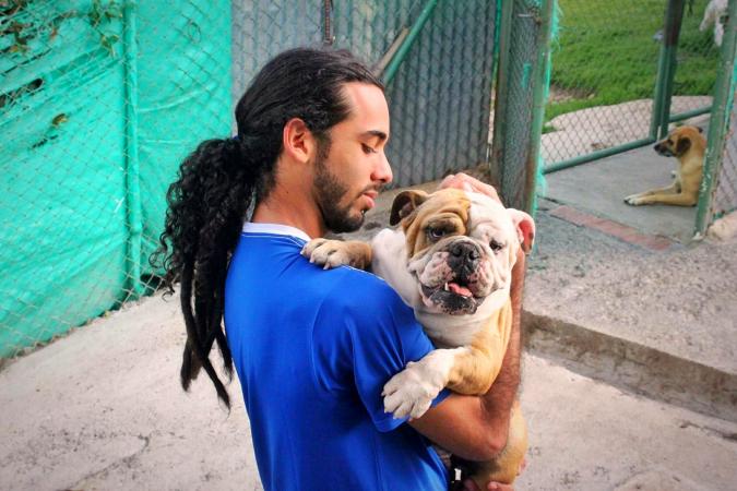 Young Man Holding Dog