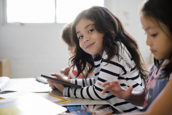 smiling girl using digital tablet