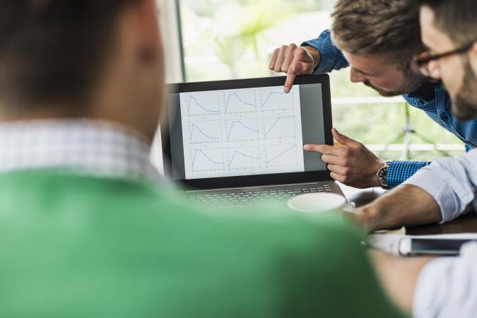 businessmen analyzing graphs