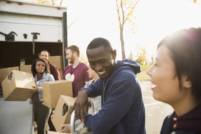 volunteers unloading cardboard boxes from truck