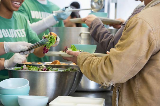 Volunteers serving food in soup kitchen