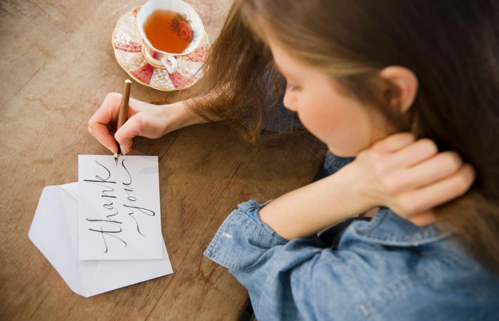 Woman writing greeting card