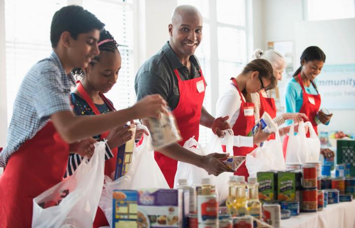 Volunteers packing canned goods at food drive