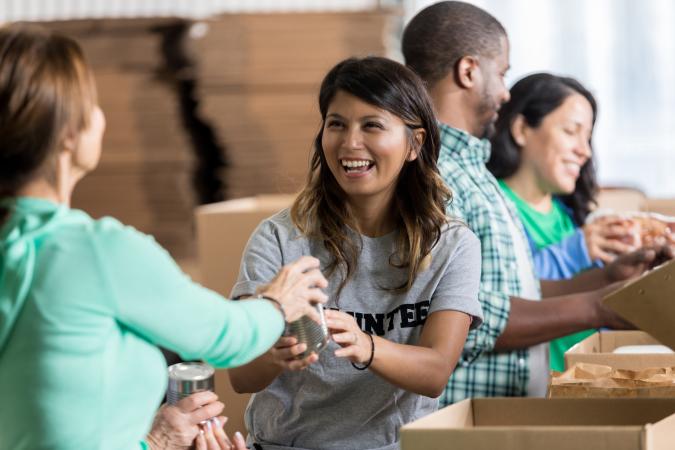 Volunteer accepts canned food donations