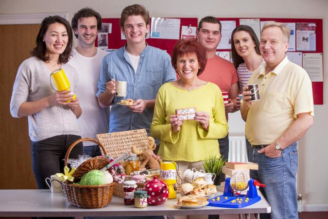 Group of people standing behind a table of raffle prizes