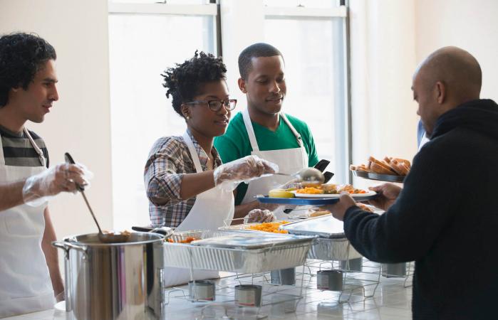 Volunteers serving food in cafeteria