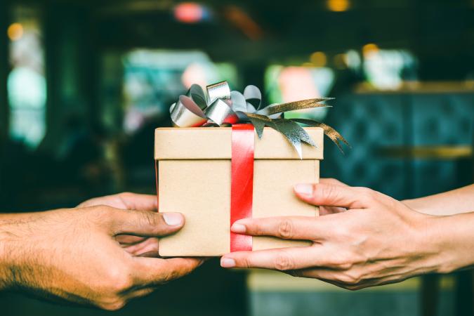 Two hands holding a present