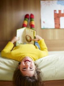 girl reading upside down