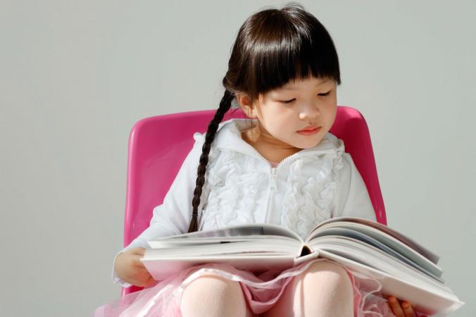 Young girl seated reading