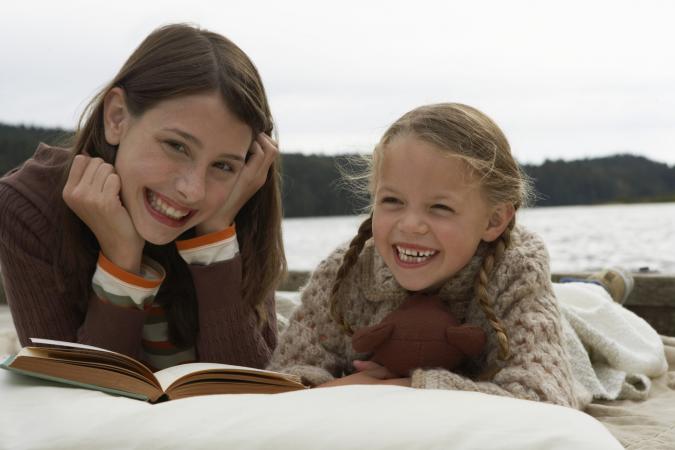 Two girls reading a book