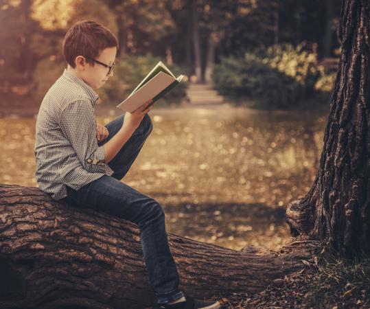boy reading outside
