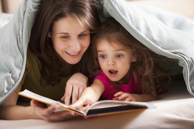 mother and daughter reading book