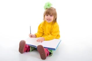 girl writing in large book