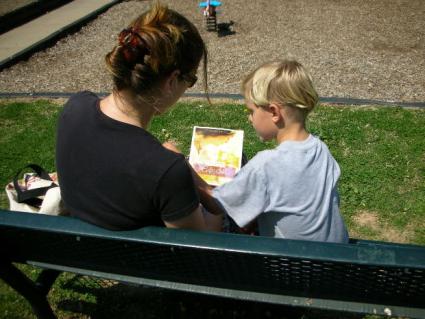 Boy and mom reading together.