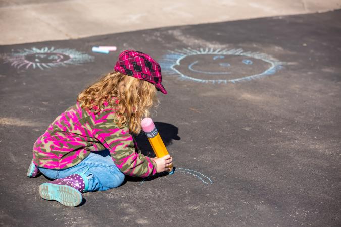 Young Girl Playing On Driveway