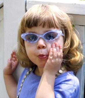 young girl in purple sunglasses