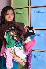 girl holding clothes