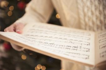 Woman holding sheet music at christmas