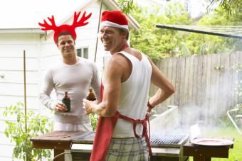 Men in Christmas hats grilling outdoors