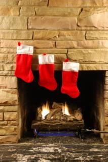 Three Christmas stocking hung on the mantle