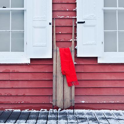 Sled propped against outside wall