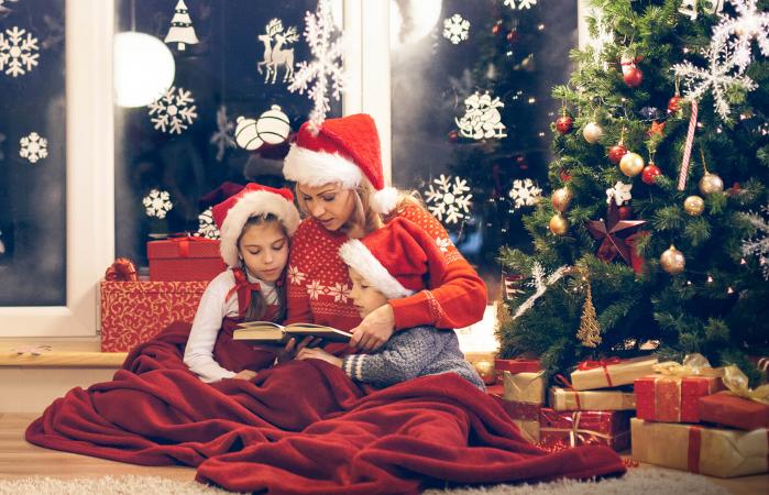 Mother reading Christmas story to her children