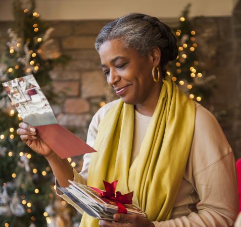 African American woman reading Christmas card