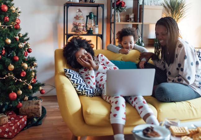 Mother and daughters watching Santa on laptop