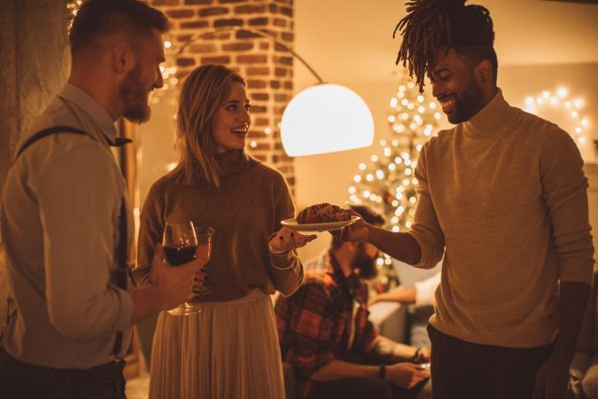 Multi ethnic group of friends having new year dinner party