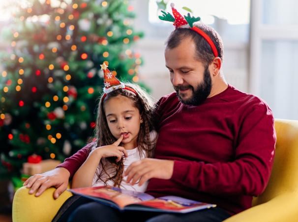 Father and daughter reading Christmas poetry together