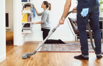 man vacuuming floor