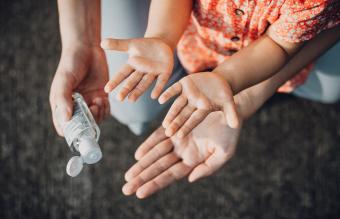 Mother squeezing hand sanitizer